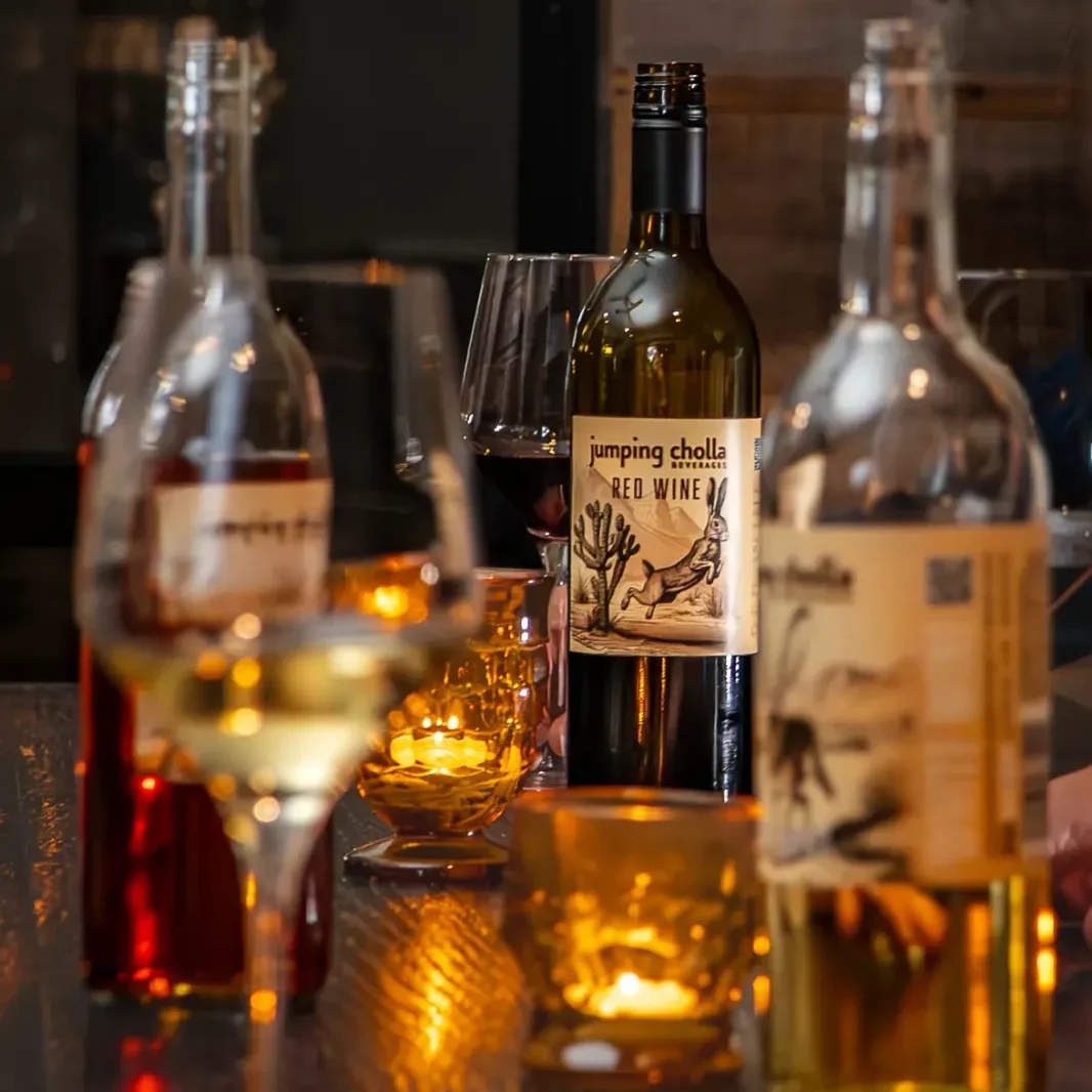 Table full of wine glasses, Jumping Cholla wine bottles, and candles